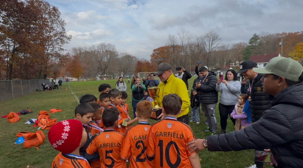 Inter NJ Garfield players receiving a trophy